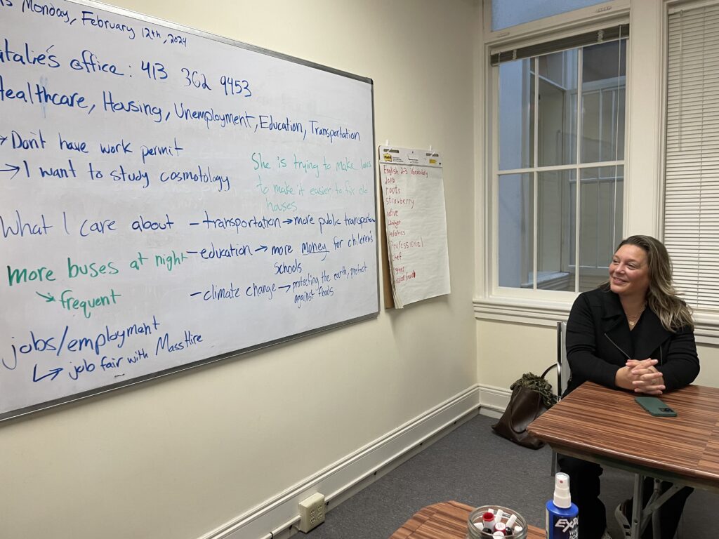 Natalie Blais looking at a whiteboard of legislative issues students expressed as important