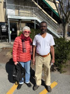 Margaret and Mateso posing together outside River Valey Co-op grocery store