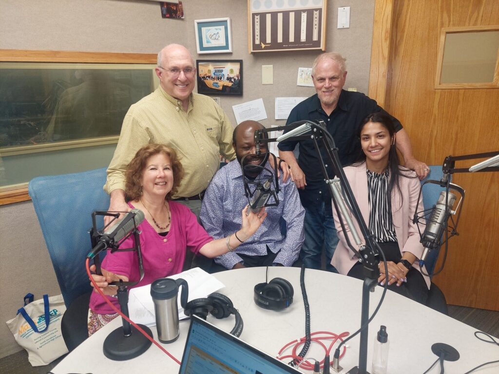 Laurie, Bill, new citizen Basilwango Kibakuli, Buzz, and Harleen pose in the Talk the Talk studio