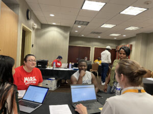 CNA and MIRA volunteers and participants using laptops together
