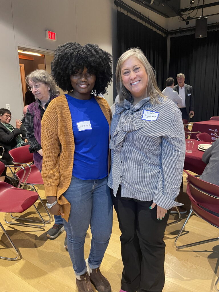 Cherline Sila, in a blue top, blush sweater, and jeans, with Allison LeDuc in a striped gray and white button down shirt and slacks.