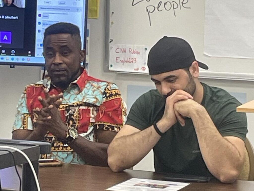 Guy (left) speaking at the Fall 2024 All Staff Meeting