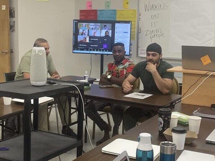 Rahmatulla (right) speaking at the Fall 2024 All Staff Meeting